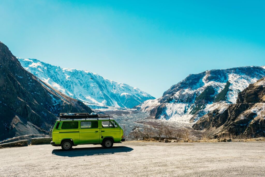 green van driving in the mountains