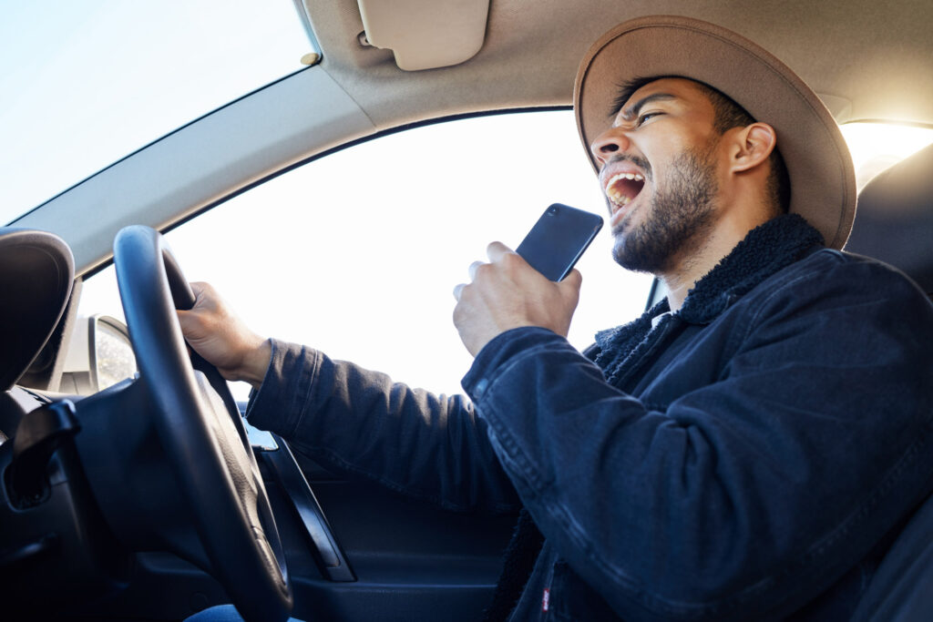 male driver listening to music while driving