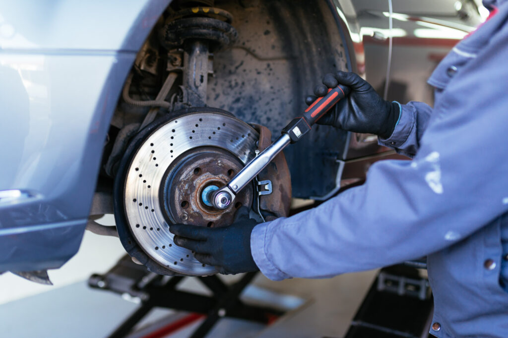 mechanic performing car brake job