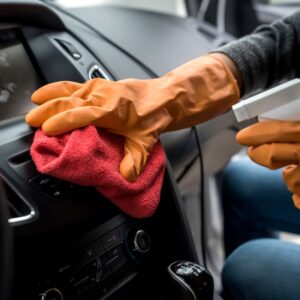 wiping and spraying a car cleaner to the dashboard