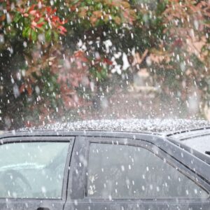 hail pouring on a black sedan