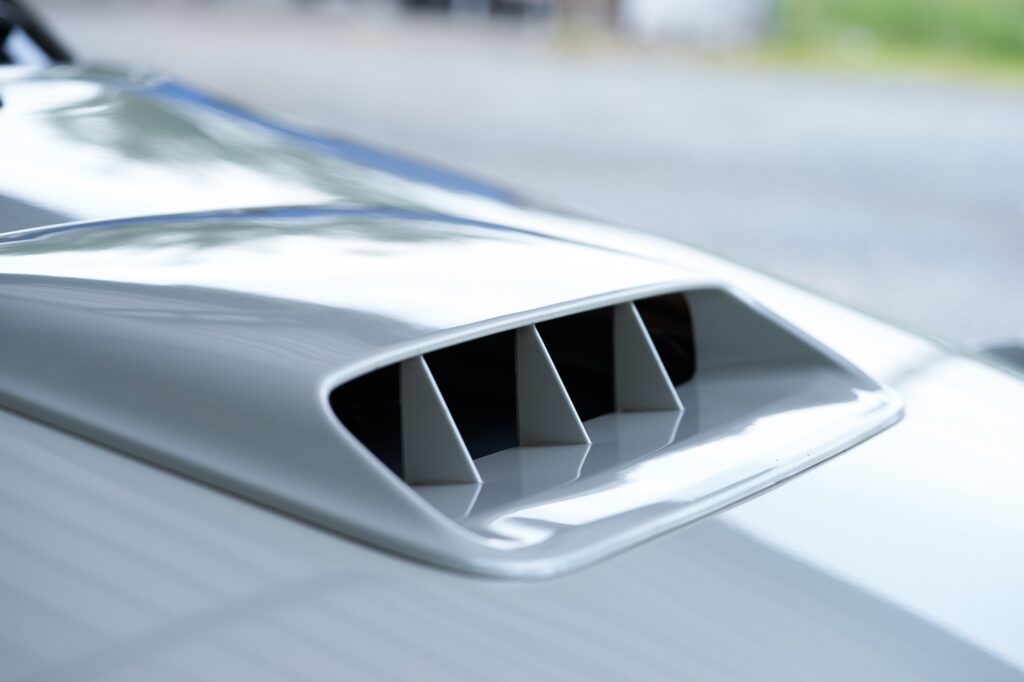 a white car with hood scoop