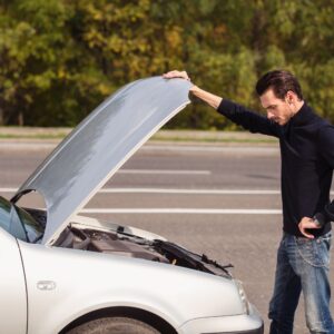 man checking car engine