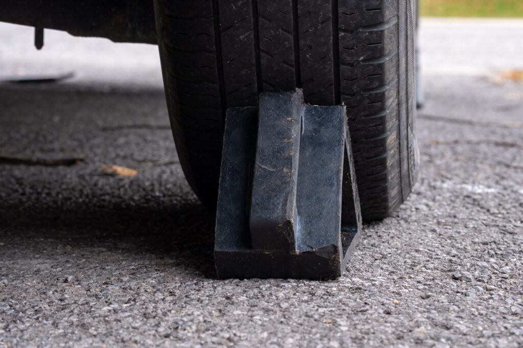 car wheel chock placed on rear wheel