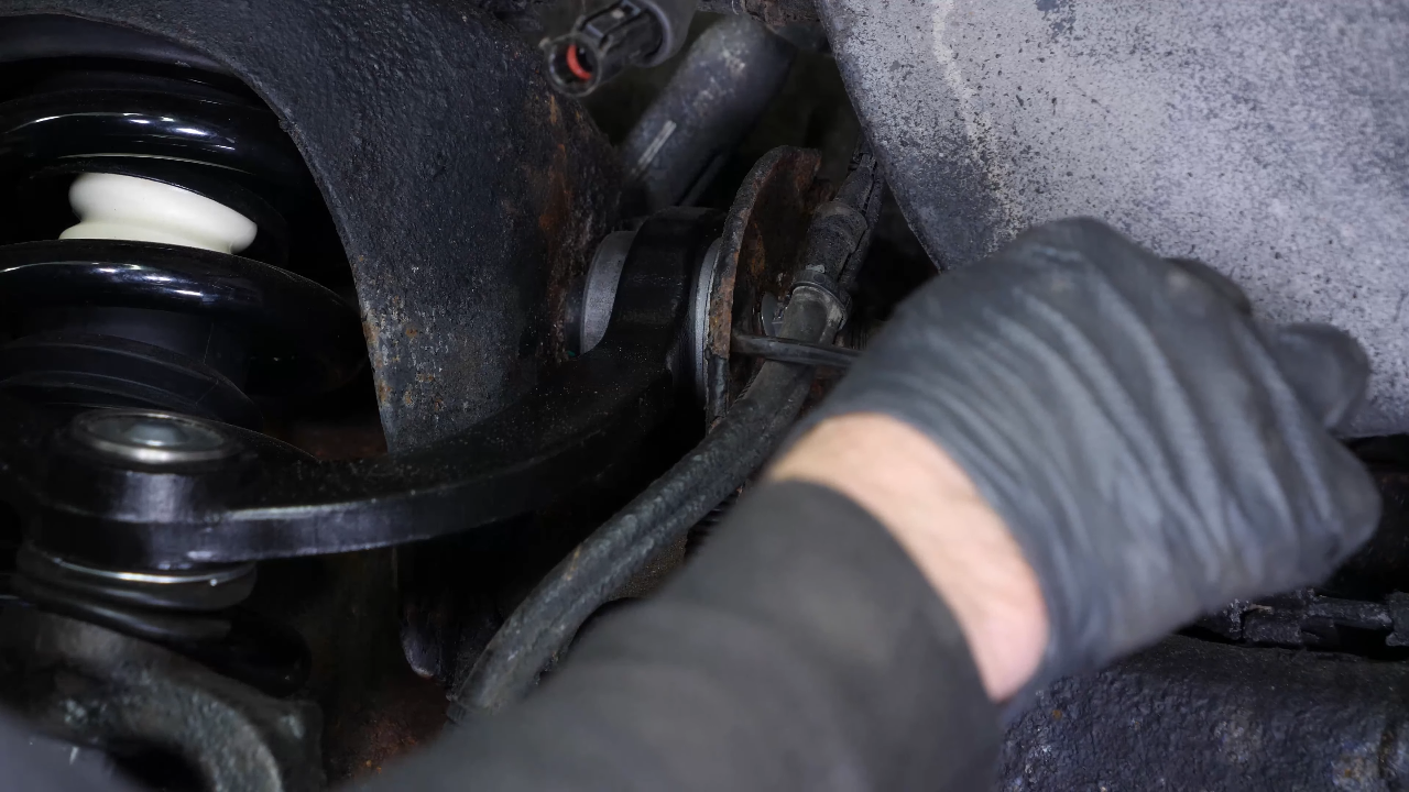 Disconnect the ABS sensor and brake hose connectors