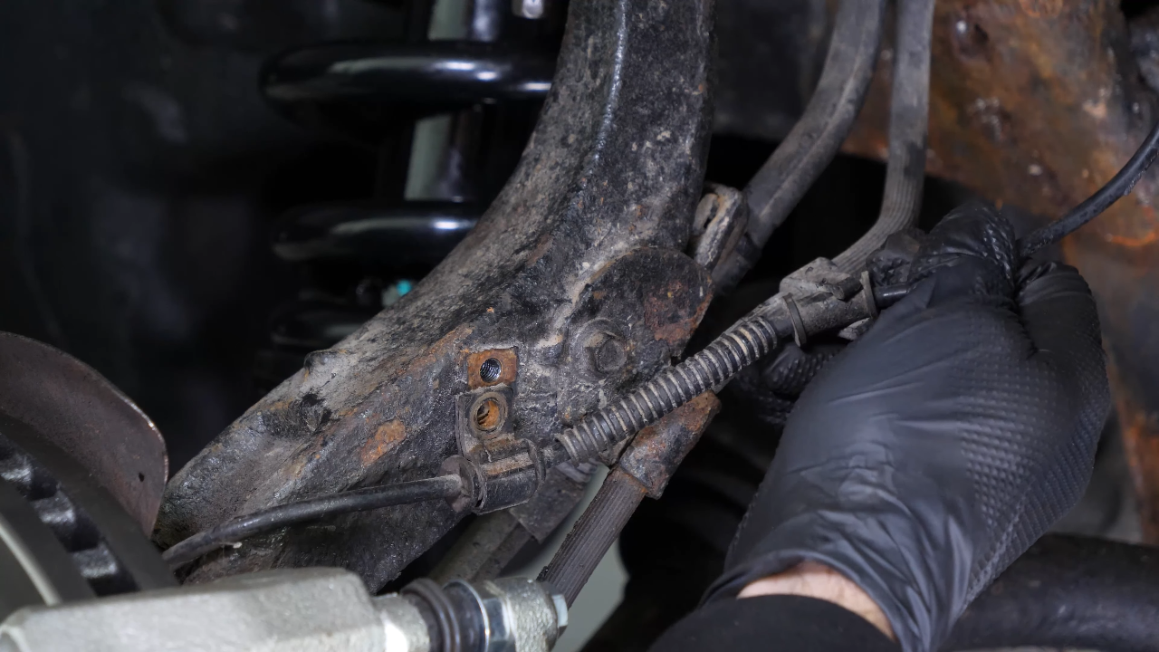 Disconnect the ABS sensor and brake hose connectors